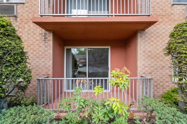 1 Lakeview Dr Unit 1L, Peekskill, NY 10566 - view of exterior entry featuring a balcony, brick siding, and stucco siding