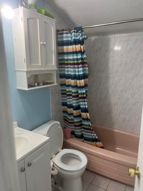 full bathroom featuring toilet, shower / tub combo, tile patterned flooring, and vanity