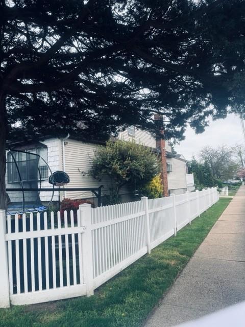 view of home's exterior with fence
