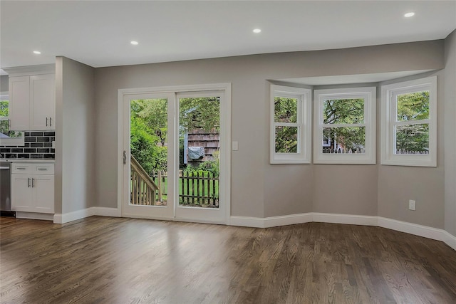 doorway with baseboards, recessed lighting, and dark wood-style floors