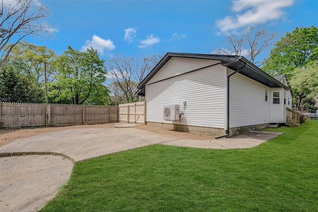 exterior space with ac unit, fence, a yard, and entry steps