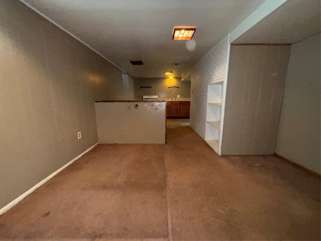 interior space featuring light colored carpet and baseboards