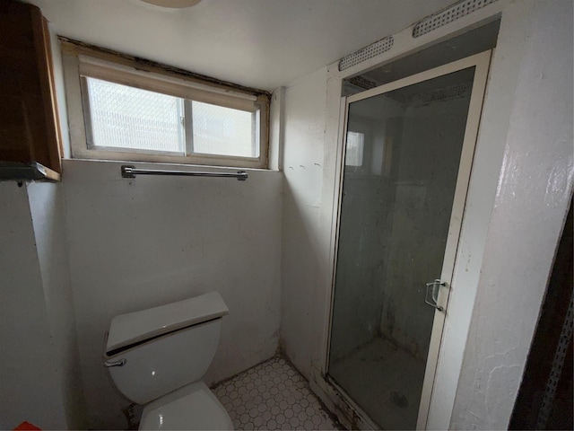 full bath with toilet and a stall shower