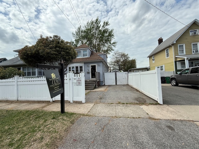 view of home's exterior featuring a gate and a fenced front yard