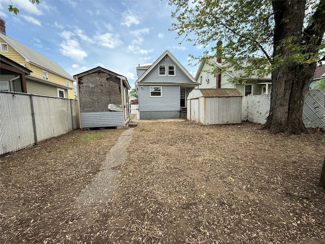 view of yard featuring a storage unit, a fenced backyard, and an outdoor structure