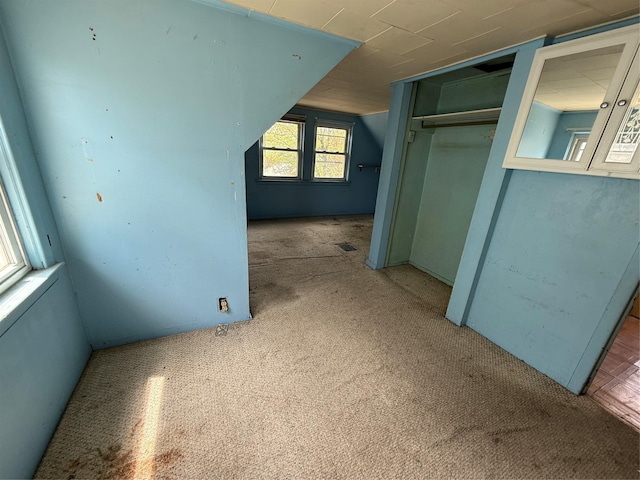 bonus room with visible vents and carpet flooring