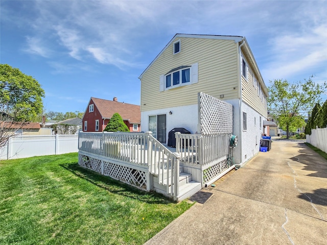 1994 Pine St, North Baldwin, NY 11510 - rear view of property featuring a wooden deck, driveway, and stucco siding