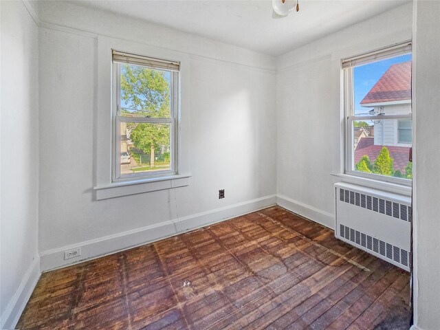1994 Pine St, North Baldwin, NY 11510 - spare room featuring radiator and dark wood-type flooring