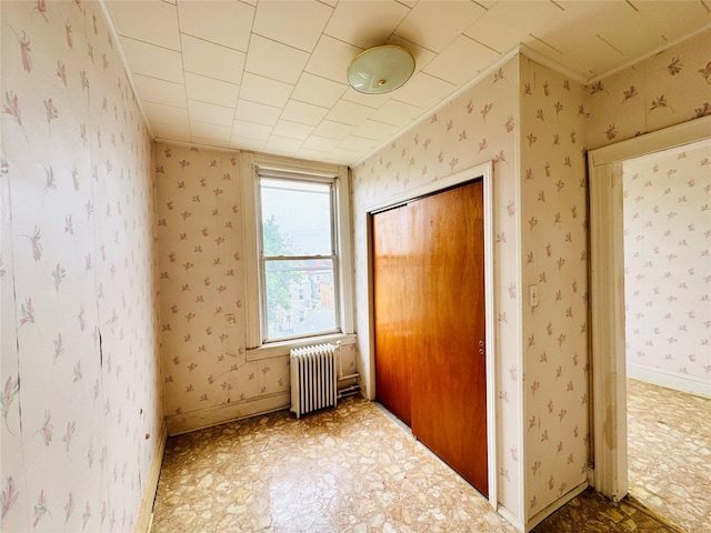 68-11 52nd Dr, Maspeth, NY 11378 - unfurnished bedroom with radiator heating unit, a closet, wallpapered walls, tile patterned floors, and ornamental molding