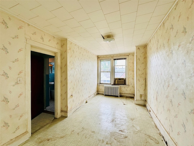 68-11 52nd Dr, Maspeth, NY 11378 - empty room featuring radiator, light flooring, wallpapered walls, and cooling unit