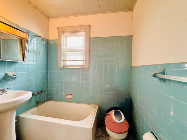 68-11 52nd Dr, Maspeth, NY 11378 - full bath featuring tile walls, a tub to relax in, a sink, and wainscoting