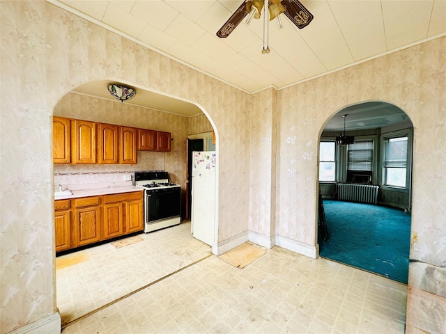 68-11 52nd Dr, Maspeth, NY 11378 - kitchen featuring white appliances, brown cabinets, ceiling fan, light flooring, and light countertops