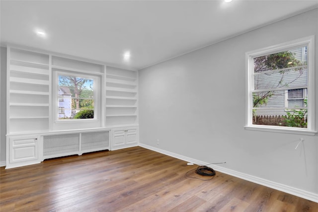 30 Inwood Rd, Glen Cove, NY 11542 - spare room with built in features, a wealth of natural light, baseboards, and radiator heating unit