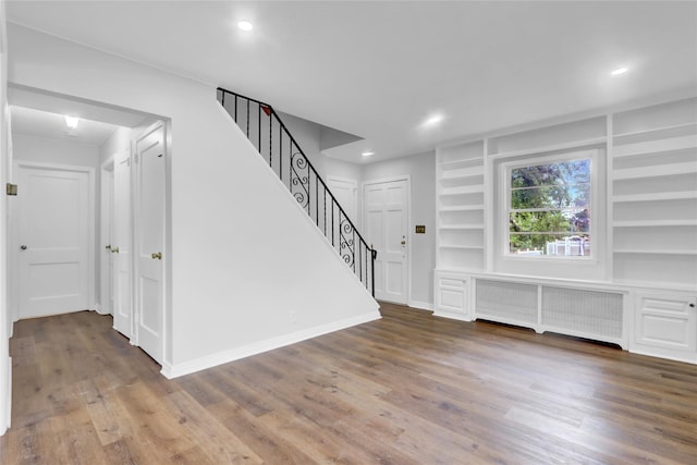 30 Inwood Rd, Glen Cove, NY 11542 - interior space with stairs, wood finished floors, radiator heating unit, built in features, and baseboards