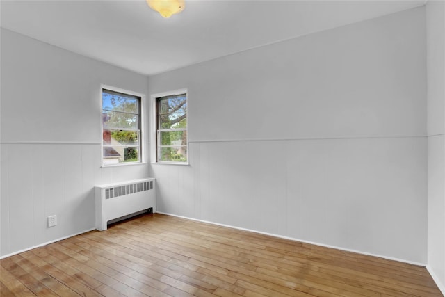 30 Inwood Rd, Glen Cove, NY 11542 - empty room with a wainscoted wall, radiator, and wood-type flooring