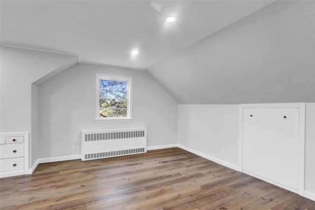 30 Inwood Rd, Glen Cove, NY 11542 - additional living space with radiator, vaulted ceiling, and wood finished floors