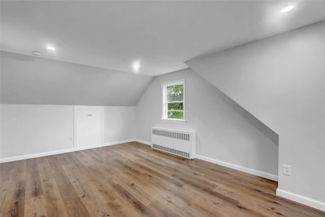 30 Inwood Rd, Glen Cove, NY 11542 - bonus room featuring lofted ceiling, radiator, baseboards, and wood finished floors