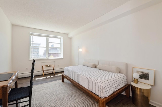 260 Bch 81st St Unit 5T, Rockaway Beach, NY 11693 - bedroom with baseboards, a baseboard radiator, and wood finished floors