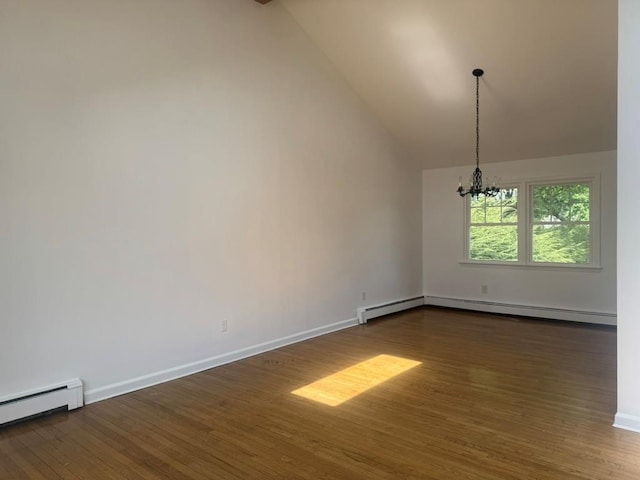 unfurnished room featuring dark wood-style flooring, a baseboard heating unit, an inviting chandelier, and vaulted ceiling