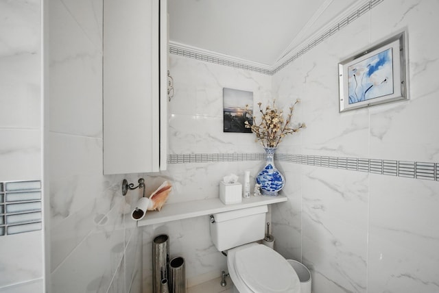 half bath featuring crown molding and toilet