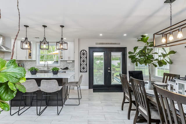 dining space featuring plenty of natural light, french doors, and recessed lighting