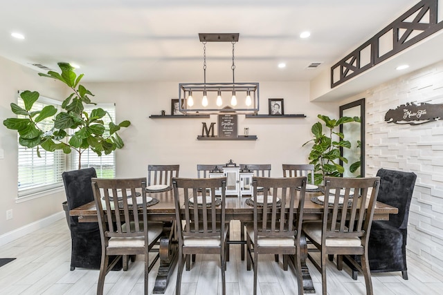 dining space featuring baseboards, wood finished floors, and recessed lighting