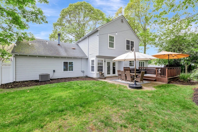 rear view of house with a deck and central AC