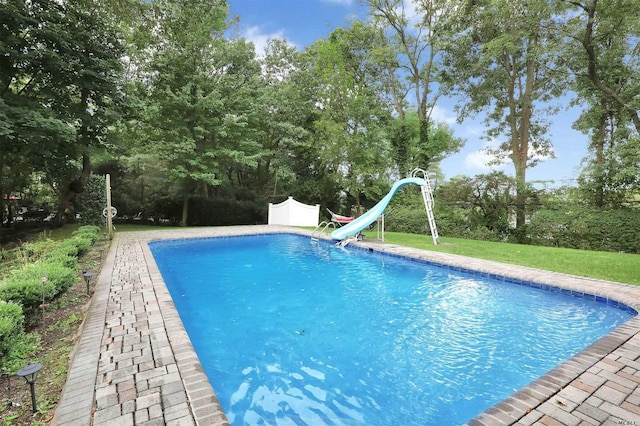 outdoor pool featuring a water slide