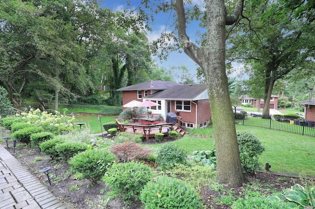 view of yard with fence and a deck