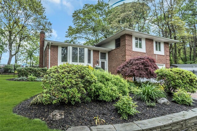 31 Elmwood Ct, Plainview, NY 11803 - view of property exterior with a chimney, brick siding, and a garage