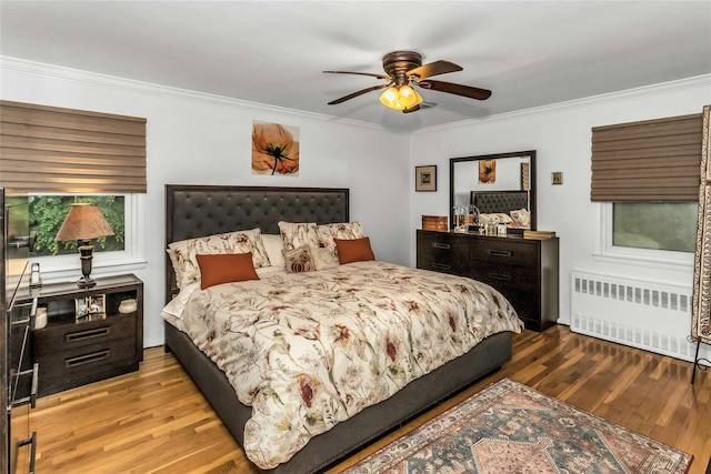 31 Elmwood Ct, Plainview, NY 11803 - bedroom with radiator, wood finished floors, crown molding, and ceiling fan