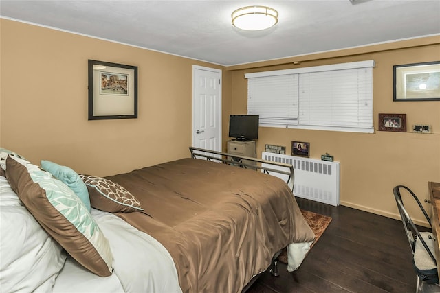 31 Elmwood Ct, Plainview, NY 11803 - bedroom with radiator, wood finished floors, and baseboards