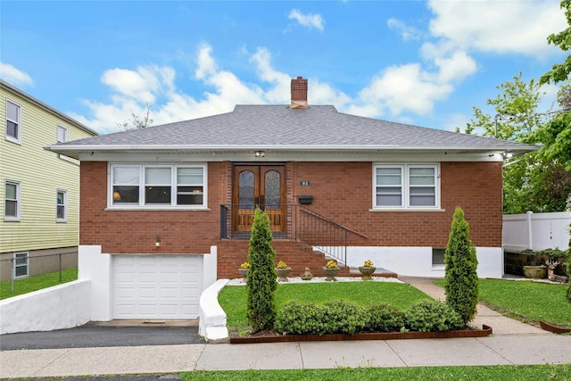 93 Crotona Ave, Harrison, NY 10528 - view of front of home featuring a garage, brick siding, a chimney, and roof with shingles