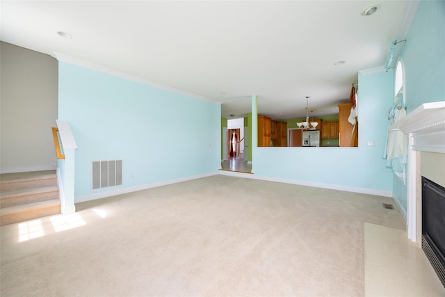 unfurnished living room with visible vents, a notable chandelier, light carpet, and stairway