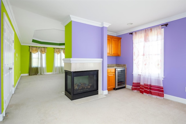 living room with beverage cooler, baseboards, crown molding, and light carpet