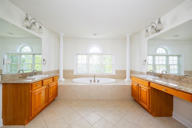 bathroom featuring tile patterned flooring, a sink, and a wealth of natural light