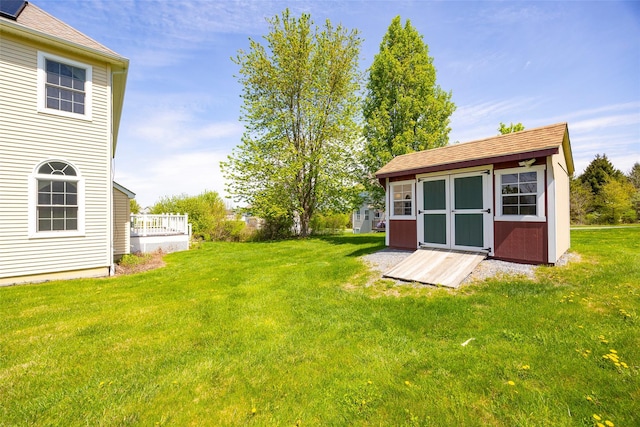 view of yard featuring a shed and an outbuilding