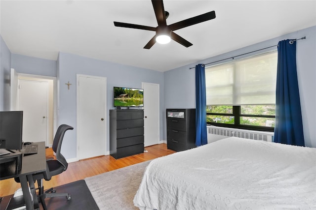 51 Rockledge Rd Unit 1A, Hartsdale, NY 10530 - bedroom with radiator heating unit, wood finished floors, a desk, and a ceiling fan