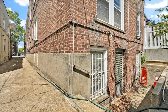 view of home's exterior with cooling unit and brick siding