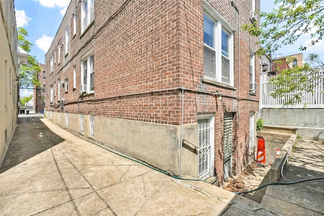 view of side of home featuring brick siding