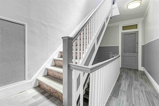 stairway featuring wood finished floors