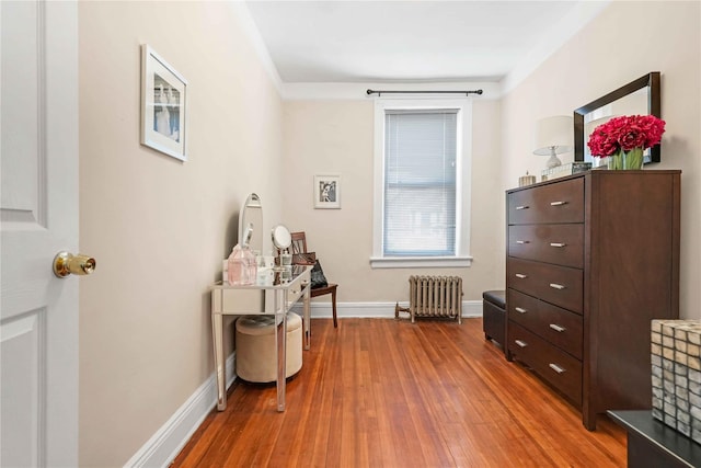 interior space with hardwood / wood-style flooring, baseboards, and radiator