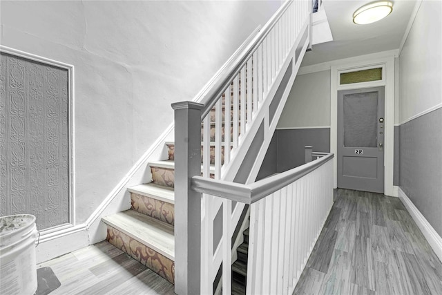 stairs featuring baseboards and wood finished floors