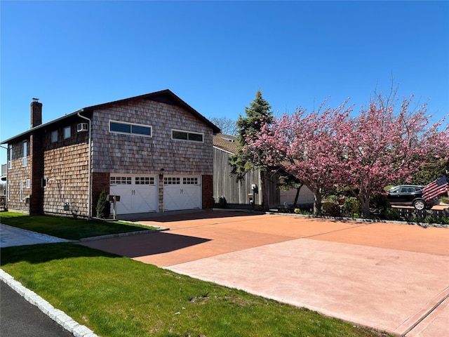 208 Block Ln, Harbor Isle, NY 11558 - view of side of home with a chimney, driveway, an attached garage, and a lawn