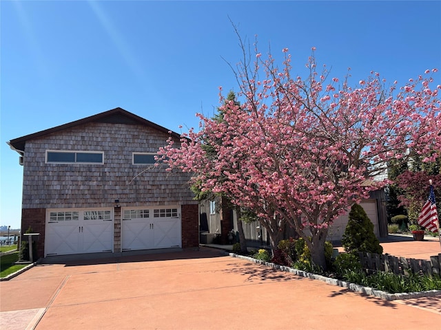 208 Block Ln, Harbor Isle, NY 11558 - view of front of home featuring concrete driveway, a garage, and brick siding