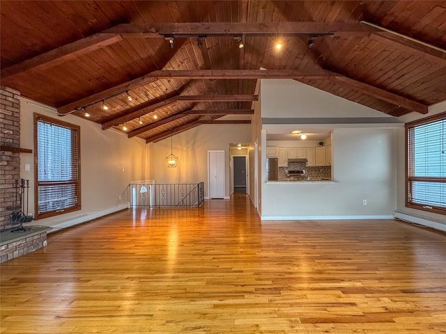 208 Block Ln, Harbor Isle, NY 11558 - unfurnished living room featuring track lighting, wood ceiling, light wood-type flooring, baseboards, and a baseboard radiator