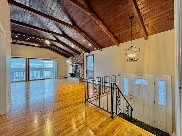 208 Block Ln, Harbor Isle, NY 11558 - entryway featuring a chandelier, wood ceiling, wood-type flooring, and a brick fireplace