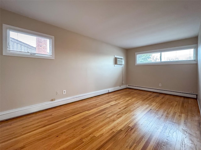 208 Block Ln, Harbor Isle, NY 11558 - unfurnished room featuring wood finished floors, an AC wall unit, a baseboard radiator, baseboards, and baseboard heating