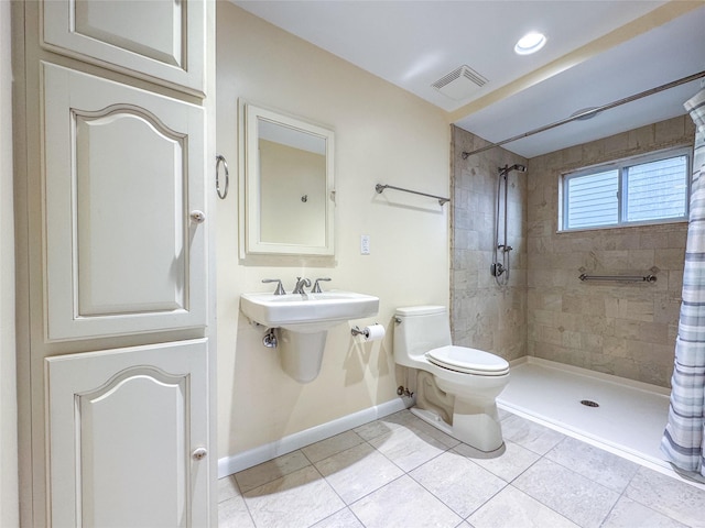 208 Block Ln, Harbor Isle, NY 11558 - full bath featuring baseboards, toilet, tiled shower, tile patterned flooring, and a sink