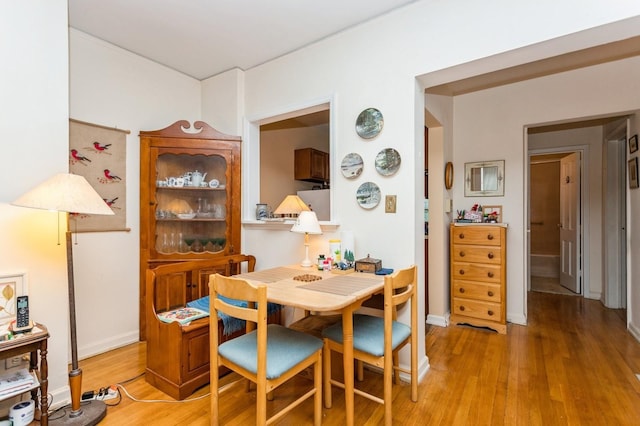 dining space with wood finished floors and baseboards